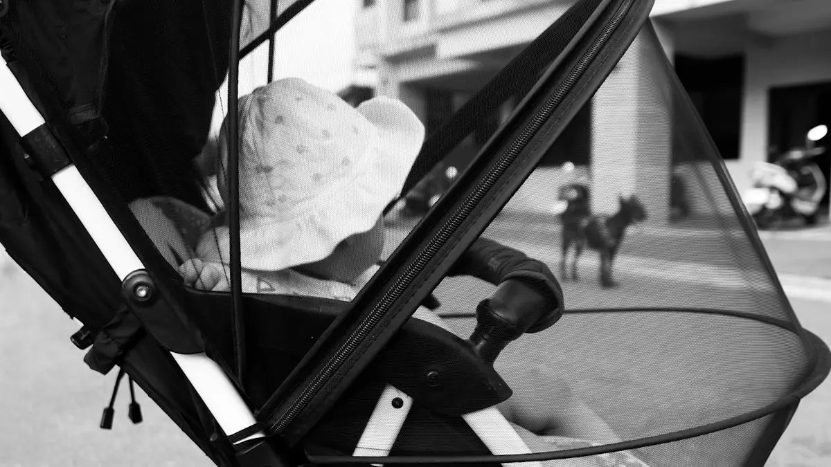 A black and white photo of a baby in a stroller